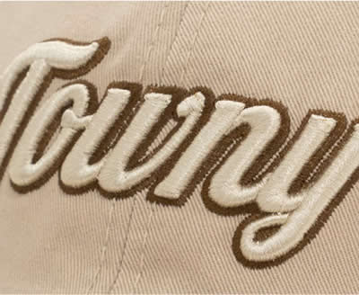 Close-up of embroidered cursive text on fabric.