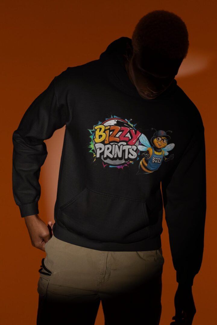 Person wearing a black sweatshirt with a colorful Bizzy Prints logo and cartoon character.