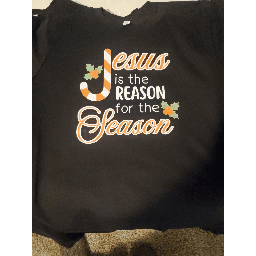 Black tote bag with 'Jesus is the reason for the season' text and star decorations.