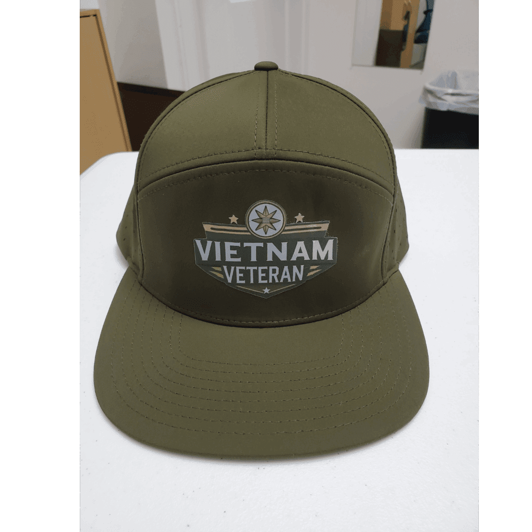 Olive green Vietnam Veteran cap with embroidered emblem and text.