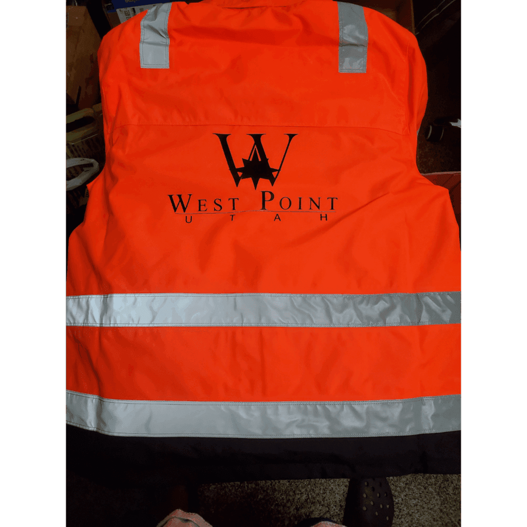 Orange safety vest with reflective stripes and West Point logo.
